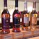 A display of different Glenmorangie Single Malt Scotch Whisky products next to a shot glass
